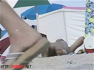 Beach cuties suspend out nude below the sun